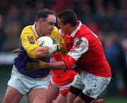 31 January 1999; Conor Deegan of  Kilmacud Crokes is tackled by Jody Morrissey of Éire Og during the AIB Leinster Club Football Championship Final 2nd Replay match between Éire Og and Kilmacud Crokes at St Conleths Park in Newbridge, Kildare. Photo by Ray McManus/Sportsfile