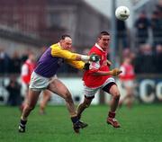 31 January 1999; Jody Morrissey of Éire Og is tackled by Conor Deegan of Kilmacud Crokes during the AIB Leinster Club Football Championship Final 2nd Replay match between Éire Og and Kilmacud Crokes at St Conleths Park in Newbridge, Kildare. Photo by Ray McManus/Sportsfile