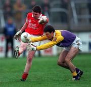 31 January 1999; Tom Nolan of Éire Og in action against John Costello of Kilmacud Crokes during the AIB Leinster Club Football Championship Final 2nd Replay match between Éire Og and Kilmacud Crokes at St Conleths Park in Newbridge, Kildare. Photo by Ray McManus/Sportsfile