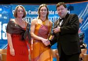 4 December 2004; Una O'Dwyer of Tipperary is presented with her All-Star award by Minister for Finance, Brian Cowen TD, and Miriam O'Callaghan, President of Cumann Camogaiochta na nGael, at the 2004 Camogie All-Star Awards. Citywest Hotel, Dublin. Picture credit; Brendan Moran / SPORTSFILE