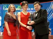 4 December 2004; Aine Codd of Wexford is presented with her All-Star award by Minister for Finance, Brian Cowen TD, and Miriam O'Callaghan, President of Cumann Camogaiochta na nGael, at the 2004 Camogie All-Star Awards. Citywest Hotel, Dublin. Picture credit; Brendan Moran / SPORTSFILE