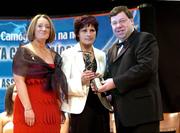 4 December 2004; Geraldine O'Connor collects an All Star award, on behalf of her daughter Gemma O'Connor of Cork, from Minister for Finance, Brian Cowen TD, and Miriam O'Callaghan, President of Cumann Camogaiochta na nGael, at the 2004 Camogie All-Star Awards. Citywest Hotel, Dublin. Picture credit; Brendan Moran / SPORTSFILE