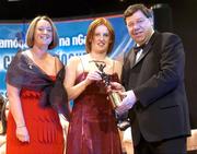 4 December 2004; Deirdre Hughes of Tipperary is presented with her All-Star award by Minister for Finance, Brian Cowen TD, and Miriam O'Callaghan, President of Cumann Camogaiochta na nGael, at the 2004 Camogie All-Star Awards. Citywest Hotel, Dublin. Picture credit; Brendan Moran / SPORTSFILE