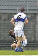 10 November 2013; Kelvin Reilly, St Loman's, falls to the ground holding his face after an altercation with Ger Brennan, St Vincent's, who later received a red card. AIB Leinster Senior Club Football Championship, Quarter-Final, St Loman's, Westmeath v St Vincent's, Dublin. Cusack Park, Mullingar, Co. Westmeath. Picture credit: Pat Murphy / SPORTSFILE