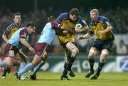 10 December 2004; Malcolm O'Kelly, Leinster, supported by team-mate Leo Cullen, is tackled by Julien Frier, Bourgoin. Heineken European Cup 2004-2005, Pool 2, Round 4, Bourgoin v Leinster, Bourgoin-Jailleau, France. Picture credit; Brendan Moran / SPORTSFILE