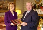 20 December 2004; President Mary McAleese is presented with a copy of &quot; A Season of Sundays 2004 &quot; by Ray McManus of Sportsfile during a visit to Aras an Uachtarain. Picture credit; Brendan Moran / SPORTSFILE