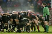 18 December 2004; Referee Iain Ramage looks on as the Munster and Ospreys packs engage a scrum. Celtic League 2004-2005, Munster v Neath Swansea Ospreys, Musgrave Park, Cork. Picture credit; Brendan Moran / SPORTSFILE