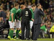 15 November 2013; Republic of Ireland manager Martin O'Neill looks on at the game as assistant manager Roy Keane issues instructions to substitutes, from left, Kevin Doyle, Paul Green and Anthony Stokes. Three International Friendly, Republic of Ireland v Latvia, Aviva Stadium, Lansdowne Road, Dublin. Picture credit: Brendan Moran / SPORTSFILE