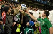 15 November 2013; Shane Long, Republic of Ireland, hands the match ball to his seven year old nephew Eamon Long after the game. Three International Friendly, Republic of Ireland v Latvia, Aviva Stadium, Lansdowne Road, Dublin. Picture credit: David Maher / SPORTSFILE