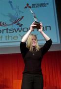 14 January 2005; Jockey Cathy Gannon, who in 2004 became the first woman ever to win the Apprentice Jockey of the year title in Ireland, lifts her Irish Times Mitsubishi Electric Sportswoman of the Year Award. Mansion House, Dublin. Picture credit; Brian Lawless / SPORTSFILE