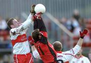 16 January 2005;  Paul Murphy, left, and Johnny McBride, Derry, in action against Alan Molloy, Down. McKenna Cup, Down v Derry, Pairc an Iuir, Newry, Co. Down. Picture credit; David Maher / SPORTSFILE