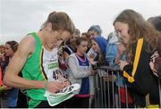 17 November 2013; Fionnuala Britton, Kilcoole A.C, Co. Wicklow, signs autographs for fans after the 2013 Woodie’s DIY Inter County & Juvenile Even Age Cross Country Championships of Ireland. Santry Demesne, Santry, Co. Dublin. Picture credit: Ramsey Cardy / SPORTSFILE