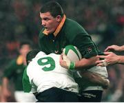 28 November 1998; Adrian Garvy, South Africa, is tackled by Ireland's Conor McGuinness. International Rugby Friendly, Ireland v South Africa, Landsdowne Road, Dublin. Picture credit: Brendan Moran / SPORTSFILE
