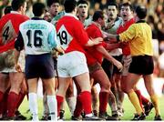 13 December 1998; Munster players Peter Clohessy and Anthony Foley, right, are restrained by referee Nigel Whitehouse. European Rugby Cup, Colomiers v Munster, Stade Toulouse, Toulouse, France. Picture credit: Matt Browne / SPORTSFILE
