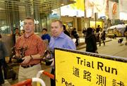 20 January 2005; A street sign, indicating a Trial Run for a pedestrian zone, as Pat McEnaney, left, and Aodan Mac Suibhne, who were presented with their Vodafone GAA Referee Awards for 2004 at a reception on the first day of the All Stars tour to Hong Kong, walk by. The Excelsior Hotel, Gloucester Road, Causeway Bay, Hong Kong. Picture credit; Ray McManus / SPORTSFILE