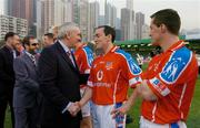 22 January 2005; An Taoiseach Bertie Ahern,T.D., is introduced to Brian Dooher, Tyrone, before the start of the game. Exhibition Game, 2003 Vodafone All-Stars v 2004 Vodafone All-Stars, Hong Kong Football Club, Hong Kong, China. Picture credit; Ray McManus / SPORTSFILE