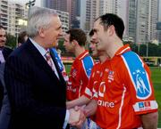22 January 2005; An Taoiseach Bertie Ahern,T.D., is introduced to Damien Diver, Donegal, before the start of the game. Exhibition Game, 2003 Vodafone All-Stars v 2004 Vodafone All-Stars, Hong Kong Football Club, Hong Kong, China. Picture credit; Ray McManus / SPORTSFILE