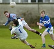 24 January 2005; Karl Costello, St. Declan's CBS, scores a point despite the attentions of Malahide CS goalkeeper Kevin Ryan and team-mate Sven Klindeberg. Dublin Schools Senior Football A Final, St. Declan's CBS v Malahide CS, St. Claire's DCU, Dublin. Picture credit; Damien Eagers / SPORTSFILE