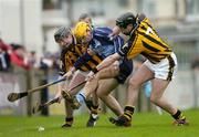 30 January 2005; David Curtin, Dublin, is tackled by Kilkenny players JJ Delaney, 7, and Martin Comerford. Walsh Cup, Dublin v Kilkenny, Parnell Park, Dublin. Picture credit; Ray McManus / SPORTSFILE