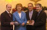 16 December 2003; President of Ireland Mary McAleesse and her husband Dr. Martin McAleesse are presented with a copy of the book 'Every Step We Took' by Tyrone manager Mickey Harte, right, and Tyrone captain Peter Canavan. Aras An Uachtarain, Phoenix Park, Dublin. Picture credit; Ray McManus / SPORTSFILE