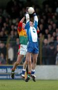6 February 2005; James McElroy, Monaghan, in action against David Byrne, Carlow. Allianz National Football League, Division 2A, Monaghan v Carlow, O'Neill Park, Clontibrit, Co. Monaghan. Picture credit; Pat Murphy / SPORTSFILE