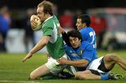 6 February 2005; Denis Hickie, Ireland, on his way to scoring his sides third try despite the tackles of Kaine Paul Robertson and Ludovico Orquera, Italy. RBS Six Nations Championship 2005, Italy v Ireland, Stadio Flamino, Rome, Italy. Picture credit; Brendan Moran / SPORTSFILE