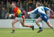 6 February 2005; David Byrne, Carlow, in action against James McElroy, Monaghan. Allianz National Football League, Division 2A, Monaghan v Carlow, O'Neill Park, Clontibrit, Co. Monaghan. Picture credit; Pat Murphy / SPORTSFILE