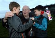 24 November 2013; Castlebar Mitchels manager Pat Holmes celebrates with his sons Joey, left, age 7 and Ben, age 5, after the game. AIB Connacht Senior Club Football Championship Final, St Brigid's, Roscommon, v Castlebar Mitchels, Mayo. Dr. Hyde Park, Roscommon. Picture credit: David Maher / SPORTSFILE