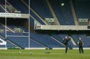 11 February 2005; Out-half Ronan O'Gara, watched by kicking coach Mark Tainton, in action during kicking practice. Ireland squad kicking practice, Murrayfield, Edinburgh, Scotland. Picture credit; Brendan Moran / SPORTSFILE