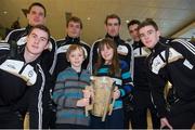 27 November 2013; Clare supporters Amy Louise Doherty, age twelve, and her brother Noah Doherty, age 9, from Spancelhill, Co. Clare, hold the Liam MacCarthy Cup with Clare players, clockwise from back left; John Conlon, David McInerney, Patrick Donnellan, Brendan Bugler, Tony Kelly, and Colm Galvin at Dublin Airport prior to their departure for Shanghai for the GAA GPA All Star Tour 2013, sponsored by Opel. Dublin Airport, Dublin. Picture credit: Pat Murphy / SPORTSFILE