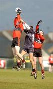 25 February 2005; Dylan Meehan, UCC, wins the ball from team-mate Patrick Kelly and Michael Moyles, Sligo IT. Datapac Sigerson Cup Semi-Final, Sligo IT v University College Cork, Dundalk IT, Dundalk, Co. Louth. Picture credit; Matt Browne / SPORTSFILE