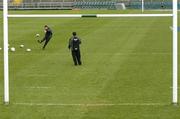 26 February 2005; Out-half Ronan O'Gara, watched by kicking coach Mark Tainton, in action during kicking practice. Ireland squad kicking practice, Lansdowne Road, Dublin. Picture credit; Brendan Moran / SPORTSFILE