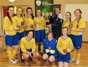 4 December 2013; The Sacred Heart School, Westport, team are presented with the trophy by Republic of Ireland Intenational Rachel Graham. FAI All-Ireland Post Primary Schools First Year Futsal Finals, Franciscan College, Sports Centre, Gormanston, Co. Meath. Picture credit: Ramsey Cardy / SPORTSFILE