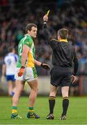 1 December 2013; Michael Murphy, Glenswilly, receives a yellow card from referee Padraig Hughes. AIB Ulster Senior Club Football Championship Final, Glenswilly, Donegal v Ballinderry Shamrocks, Derry, Healy Park, Omagh, Co. Tyrone. Picture credit: Oliver McVeigh / SPORTSFILE
