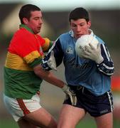 16 January 1999; Niall O'Donoghue of Dublin is tackled by Joe Byrne of Carlow during the O'Byrne Cup Quarter-Final match between Carlow and Dublin at Dr Cullen Park in Carlow. Photo by Ray McManus/Sportsfile