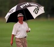 23 August 1997; Philip Walton of Ireland takes cover from the rain during the third round of the Smurfit European Open at The K Club in Straffan, Kildare. Photo by Matt Browne/Sportsfile