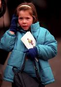 9 January 1999; A young racegoer talks on her mobile phone during the meeting at at Leopardstown Racecourse in Dublin. Photo by Ray McManus/Sportsfile