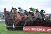 8 December 2013; Formidableopponent, with Mark Walsh up, right, followed by Butney Boy, with Sean Flanagan up, centre, and Talbot Road, with Barry Cash up, jump the final hurdle during the Setanta Sports €1 Offer Beginners Steeplechase. Punchestown Racecourse, Punchestown, Co. Kildare. Picture credit: Ramsey Cardy / SPORTSFILE