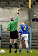 12 March 2005; Dermot Brady, Longford, is shown the yellow card by referee Padraig Seoige. Allianz National Football League, Division 2A, Clare v Longford, Cusack Park, Ennis, Co. Clare. Picture credit; Ray McManus / SPORTSFILE