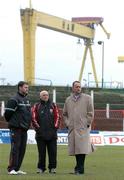 15 March 2005; Longford Town manager Alan Mathews, right, with his assistants Arron O'Callagahan, left, and Noel White view the Oval pitch with Harland and Wolff shipyard in the background. Setanta Cup 2005, Group 1, Glentoran v Longford Town, The Oval, Belfast. Picture credit; David Maher / SPORTSFILE