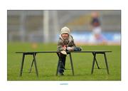 14 April 2013; 2-year-old Conor O'Riordan, from Kilmallock, Co. Limerick, climbs onto the team bench before the game. Allianz Hurling League, Division 1A, Relegation Play-off, Clare v Cork, Gaelic Grounds, Limerick. Picture credit: Diarmuid Greene / SPORTSFILE