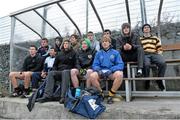 18 December 2013; Colaiste Eoin players and supporters sit in the team dugout before the game was called off. South Leinster Post Primary Schools Senior Football “A” League Final, Colaiste Eoin v Patrician Newbridge. Thomas Davis GAA Grounds, Dublin. Picture credit: Matt Browne / SPORTSFILE