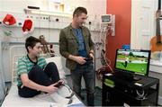 23 December 2013; Republic of Ireland international Robbie Keane plays a golf game on a xbox with, 15 year old, Niall O'Grady, from Raheny, Co. Dublin, during a visit to Temple Street Children's University Hospital, Temple Street, Dublin. Picture credit: David Maher / SPORTSFILE