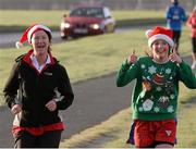 25 December 2013; Kate and Clare McCarthy, from Dunboyne, Co Meath, in action during the Goal Mile Christmas Day 2013. Papal Cross, Phoenix Park, Dublin. Picture credit: Ray McManus / SPORTSFILE