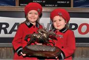 26 December 2013; Katie McManus, left, aged 6, and her sister Vivienne, aged 5, both grandchildren of winning owner JP McManus, hold the winners trophy after Defy Logic, with Mark Walsh up, won the Racing Post Novice Steeplechase. Leopardstown Christmas Racing Festival 2013, Leopardstown Racetrack, Leopardstown, Co. Dublin. Picture credit: Barry Cregg / SPORTSFILE