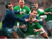 6 February 1999; Conor McGuinness, Ireland, is tackled by Thomas Lievremont and Thomas Castaignede, left, France.  Five Nations Rugby Championship, Ireland v France, Lansdowne Road, Dublin. Picture credit: Brendan Moran / SPORTSFILE