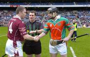 17 March 2005; Athenry captain Eugene Cloonan, left, shakes hands with James Stephens captain Peter Barry in the company of referee Seamus Roche. AIB All-Ireland Club Senior Hurling Championship Final, Athenry v James Stephens, Croke Park, Dublin. Picture credit; Ray McManus / SPORTSFILE