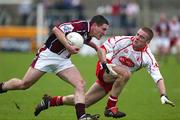 27 March 2005; Peter Torme, Westmeath, in action against Philip Jordan, Tyrone . Allianz National Football League, Division 1A, Westmeath v Tyrone, Cusack Park, Mullingar, Co. Westmeath. Picture credit; Oliver McVeigh / SPORTSFILE