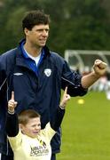 29 March 2005; Former Republic of Ireland international Niall Quinn poses for a photo with Dion Piggott during the Dublin Docklands Festival of football. This event, which takes place from 29th to 31st March, has been developed to help young people from the Docklands area of Dublin to develop their skills and come more confident and accomplished players. Teaching the soccer skills are soccer stars Niall Quinn, Ray Houghton, Don Givens, Bobby Saxton and Chris Nichol. Tolka Rovers FC, Frank Cooke Park, Griffith Avenue, Dublin. Picture credit; Brendan Moran / SPORTSFILE