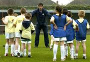 29 March 2005; Former Republic of Ireland international Niall Quinn showing some skills to kids from the docklands area of Dublin during the Dublin Docklands Festival of football. This event, which takes place from 29th to 31st March, has been developed to help young people from the Docklands area of Dublin to develop their skills and come more confident and accomplished players. Teaching the soccer skills are soccer stars Niall Quinn, Ray Houghton, Don Givens, Bobby Saxton and Chris Nichol. Tolka Rovers FC, Frank Cooke Park, Griffith Avenue, Dublin. Picture credit; Brendan Moran / SPORTSFILE